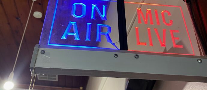 On Air sign with First Nations flag in background