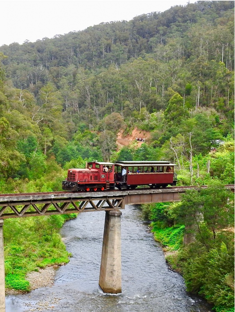Colour photo of Walhalla rail train crossing a bridge over a river.