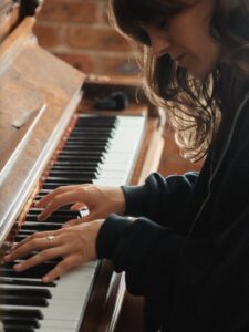 Colour photo of Tig playing piano.